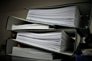 Close-up of stacked binders filled with documents for office or educational use.